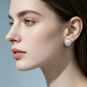 Detailed macro shot of a silver checkered lattice stud earring on a model's ear