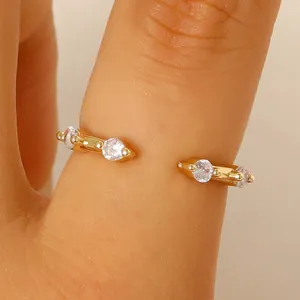 Minimalist gold plated open ring featuring four sparkling round cubic zirconia stones