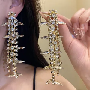 Detailed close-up of sparkling fishbone-shaped tassel earrings with clear rhinestone crystals
