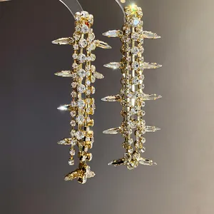Exquisite detailed view of long gold-tone tassel earrings featuring glittering marquise rhinestones