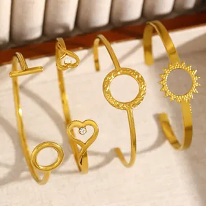 Set of 4 minimalist matte gold open bangles with elegant heart and sunburst designs