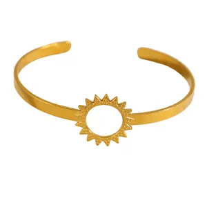 Minimalist gold sunburst open cuff bracelet featuring a textured celestial sun motif detail