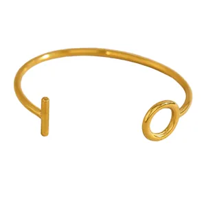 Detailed view of minimalist gold open bangle with elegant T-bar and O-ring closure design
