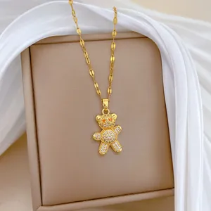 Detailed macro shot of a titanium steel gold bear pendant necklace with sparkling zircons.