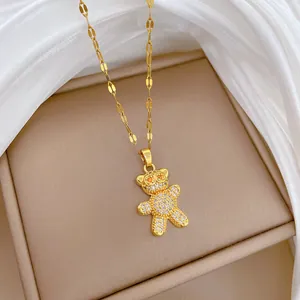 Detailed macro view of a gold-plated titanium steel bear necklace with micro-paved stones