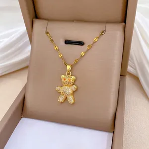 Close-up of titanium steel gold bear necklace pendant with pave set clear crystals