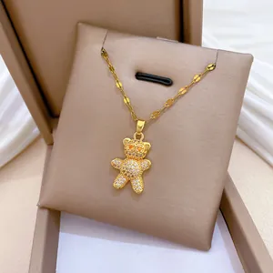 Detailed view of a gold-plated titanium steel necklace with a sparkling micro-paved bear pendant.