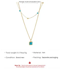 Detailed view of bohemian double-layered gold chain necklace with turquoise square pendant