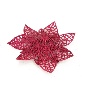 Close-up of a magenta hollow-out glitter Poinsettia flower for Christmas tree decor.