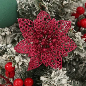 Macro detail of red glitter hollow-out poinsettia flower for Christmas tree decoration