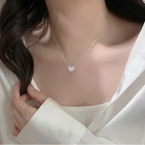Detailed view of a silver lily of the valley pendant necklace on a delicate chain.