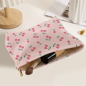 Adorable pink corduroy makeup bag with hand-drawn cherry prints and durable zipper
