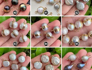 Close-up of various natural baroque pearls with gold-plated edges for jewelry making