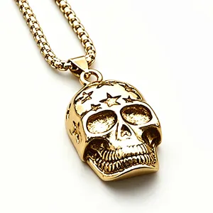 Detailed macro shot of the golden skull pendant with star engravings on the forehead.