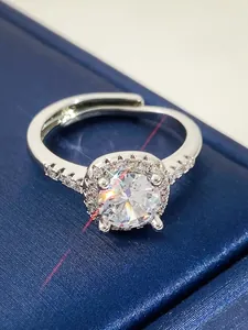 Close-up macro detail of a sparkling silver adjustable ring with a brilliant center zircon