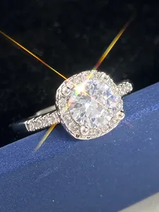 Close-up detail of a sparkling round zircon halo ring inside a blue jewelry box