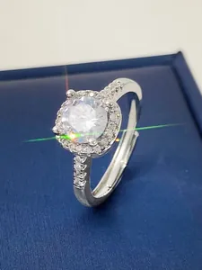 Detailed view of an adjustable silver ring featuring a sparkling round halo zircon stone.
