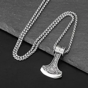 Detail view of Viking axe pendant with intricate Nordic engravings on titanium steel.