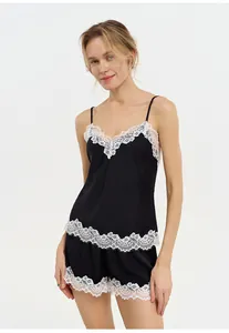 Elegant black satin pajama set with white lace trim including camisole and shorts detail