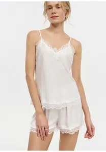 Detailed view of white French lace pajama set with silk-like camisole and shorts