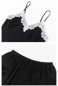 Detailed view of a black satin pajama set with elegant white lace and thin straps