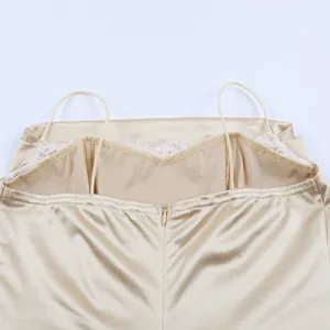 Close-up detail of champagne satin dress with delicate lace trim and hidden back zipper