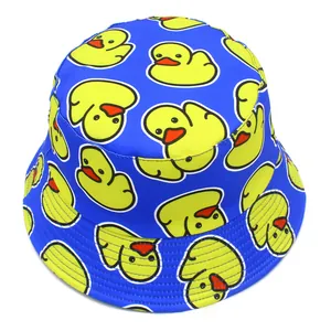 Close-up detail of a bright blue bucket hat featuring a playful yellow cartoon duck pattern.