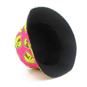 Detailed view of a vibrant pink bucket hat with playful yellow cartoon duck print patterns