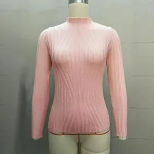 Detailed view of a light pink wide-ribbed turtleneck knit sweater on a shop mannequin