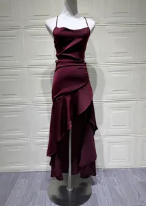 Detailed view of burgundy backless camisole dress with elegant ruffled irregular hem