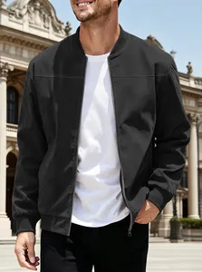 Close-up detail of a men's black suede-like bomber jacket worn by a model in a plaza.