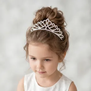 Detail view of an elegant heart-shaped rhinestone princess tiara worn by a young girl