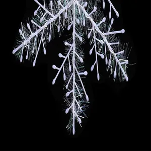 Macro detail of white iridescent snowflake pendant with fine brushed wire texture.