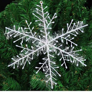 Large 11cm white tinsel snowflake ornament hanging on a green Christmas tree branch