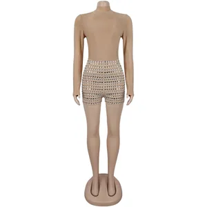 Detailed front view of a sexy long-sleeve beige rhinestone bodysuit on a mannequin