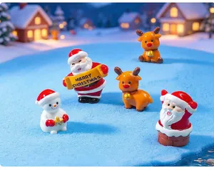 Gros plan de mignonnes figurines de Noël miniatures sur neige bleue
