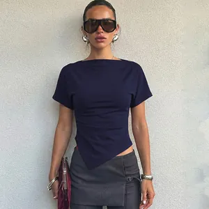 Model wearing dark blue slim-fit T-shirt with asymmetrical diagonal hem detail
