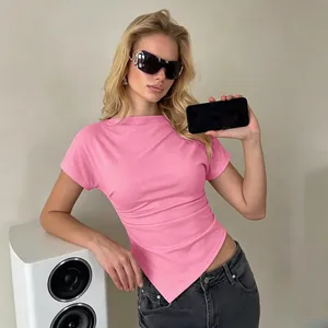Pink slim-fit t-shirt with irregular pointed hem worn by model in a modern setting
