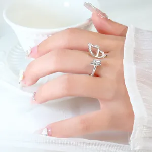 Close-up of elegant silver zircon butterfly ring on hand with asymmetrical wings