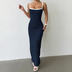 Detail view of navy blue bodycon maxi dress with white contrast spaghetti straps.