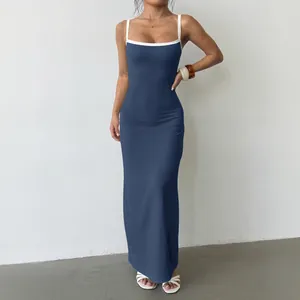 Elegant slim fit navy blue knit maxi dress with white contrast straps on female model