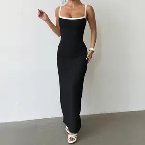 Elegant black bodycon maxi dress with white contrast spaghetti straps and slim fit silhouette