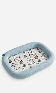 Summer cooling ice silk dog bed with cute rabbit pattern in a cozy indoor home setting.