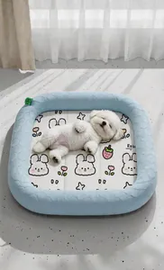 White dog sleeping in a light blue cooling ice silk pet nest with rabbit patterns