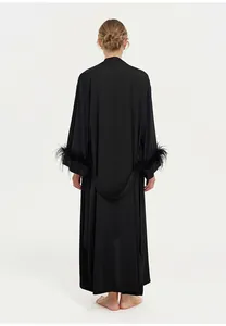 Back view of black acetate long robe featuring elegant ostrich feather trimmed cuffs