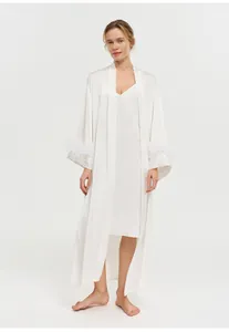 Close-up of white acetate nightgown set featuring elegant ostrich feather cuffs.