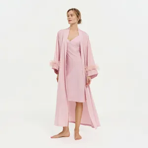 Elegant pink satin sleepwear set with ostrich feather cuffs and matching slip dress.
