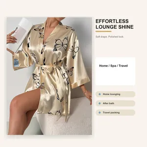 Detailed view of champagne satin robe with butterfly print and waist tie design
