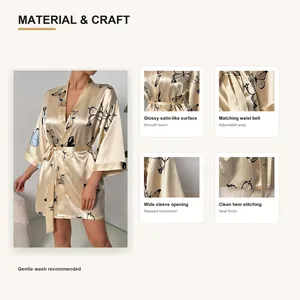 Detailed macro view of champagne silk-like satin robe featuring elegant butterfly print