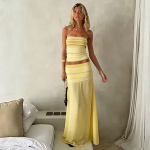 Stylish yellow striped tube top paired with a semi-sheer mesh maxi skirt for spring